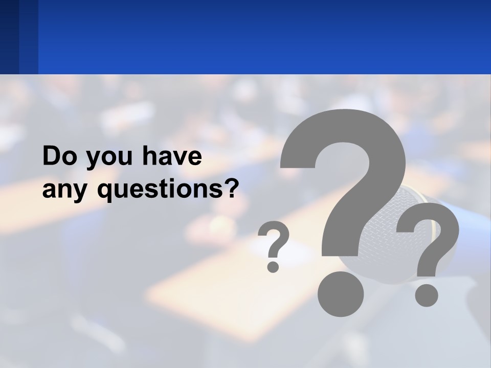 A Microphone In Front Of A Lecture Hall Full Of People PowerPoint Template