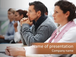 A Group Of People Sitting In Front Of A Laptop Computer PowerPoint Template