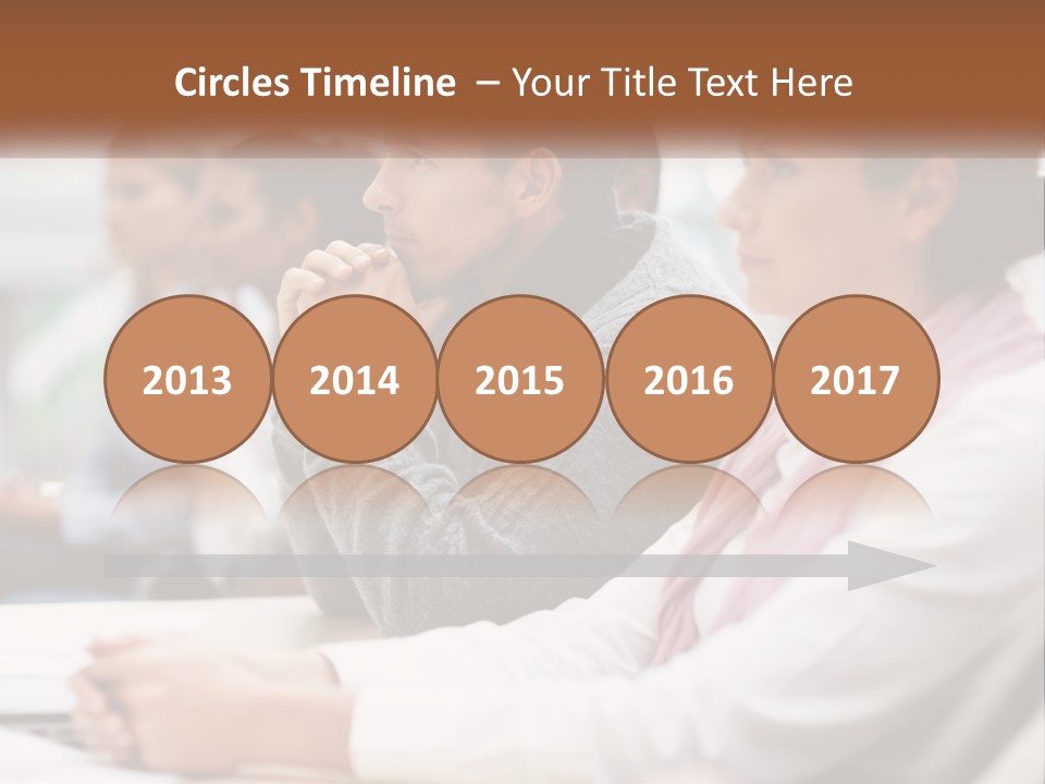 A Group Of People Sitting In Front Of A Laptop Computer PowerPoint Template