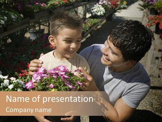 A Man Holding A Child In A Flower Shop PowerPoint Template