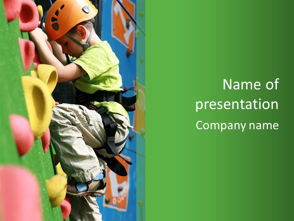 A Young Boy Climbing Up The Side Of A Climbing Wall PowerPoint Template