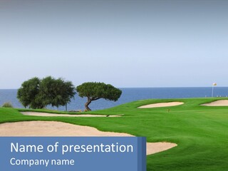 A Golf Course With A Tree And Water In The Background PowerPoint Template