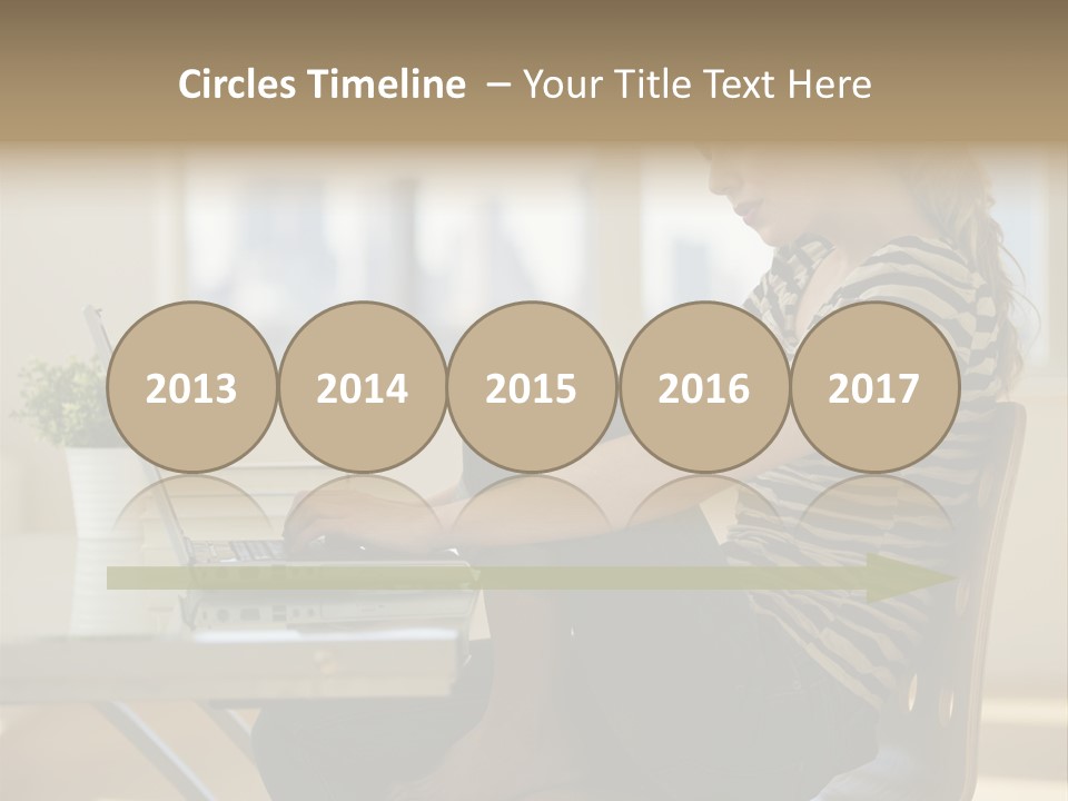 A Woman Sitting On A Chair Using A Laptop Computer PowerPoint Template