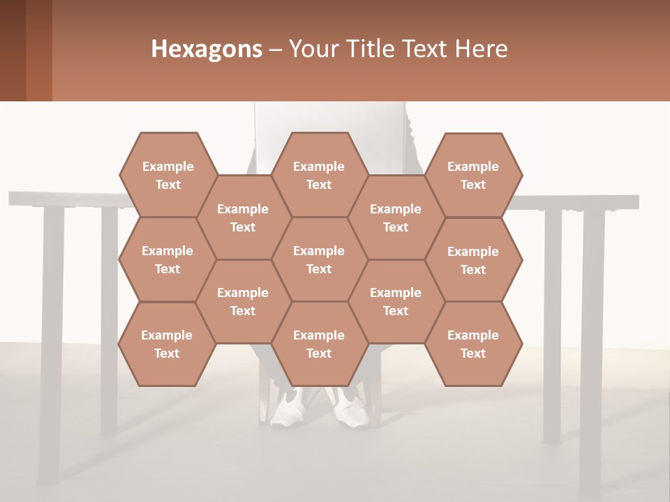 A Man Sitting At A Table Using A Laptop Computer PowerPoint Template