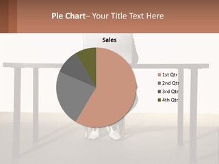 A Man Sitting At A Table Using A Laptop Computer PowerPoint Template