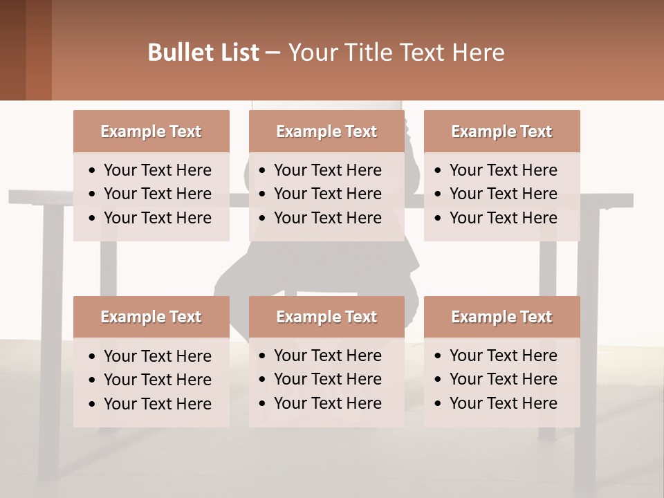 A Man Sitting At A Table Using A Laptop Computer PowerPoint Template