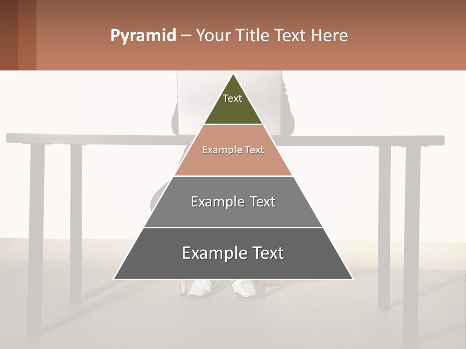 A Man Sitting At A Table Using A Laptop Computer PowerPoint Template