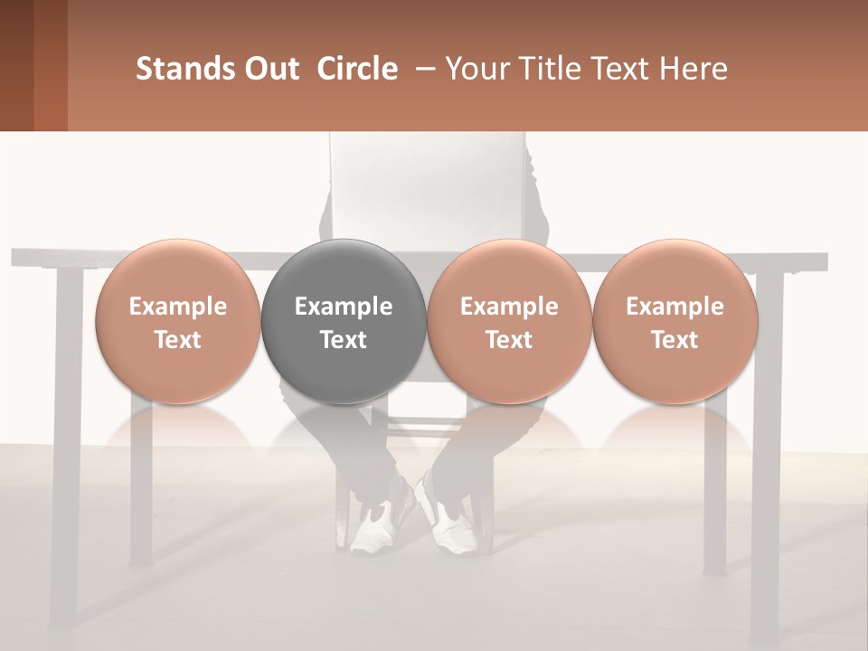 A Man Sitting At A Table Using A Laptop Computer PowerPoint Template