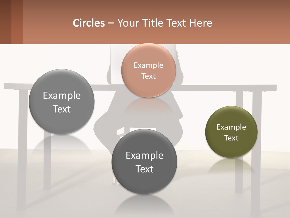 A Man Sitting At A Table Using A Laptop Computer PowerPoint Template