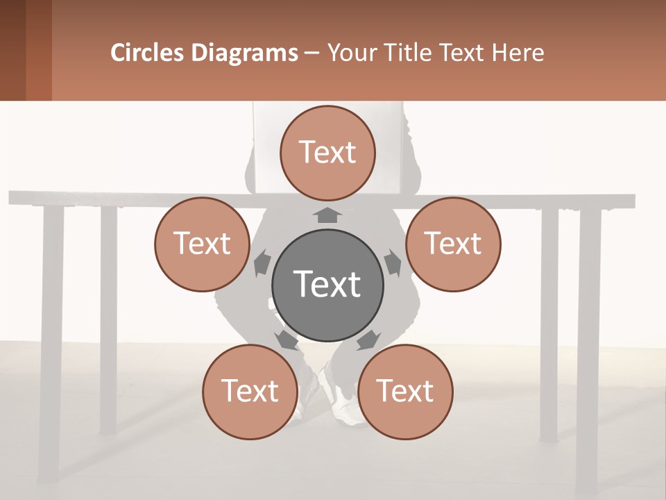 A Man Sitting At A Table Using A Laptop Computer PowerPoint Template