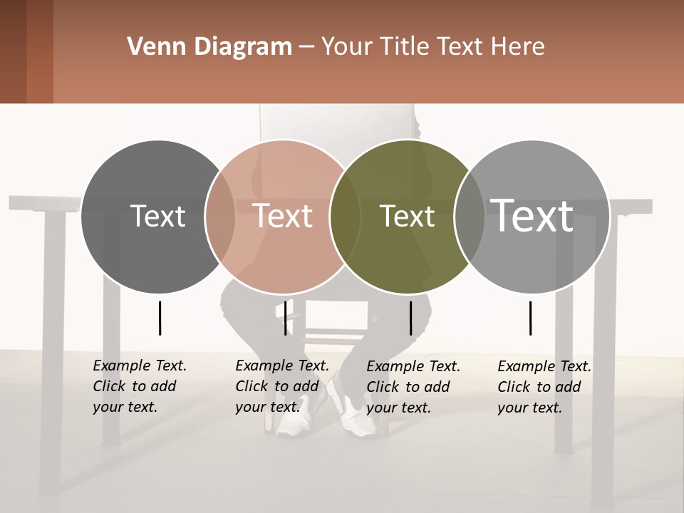 A Man Sitting At A Table Using A Laptop Computer PowerPoint Template