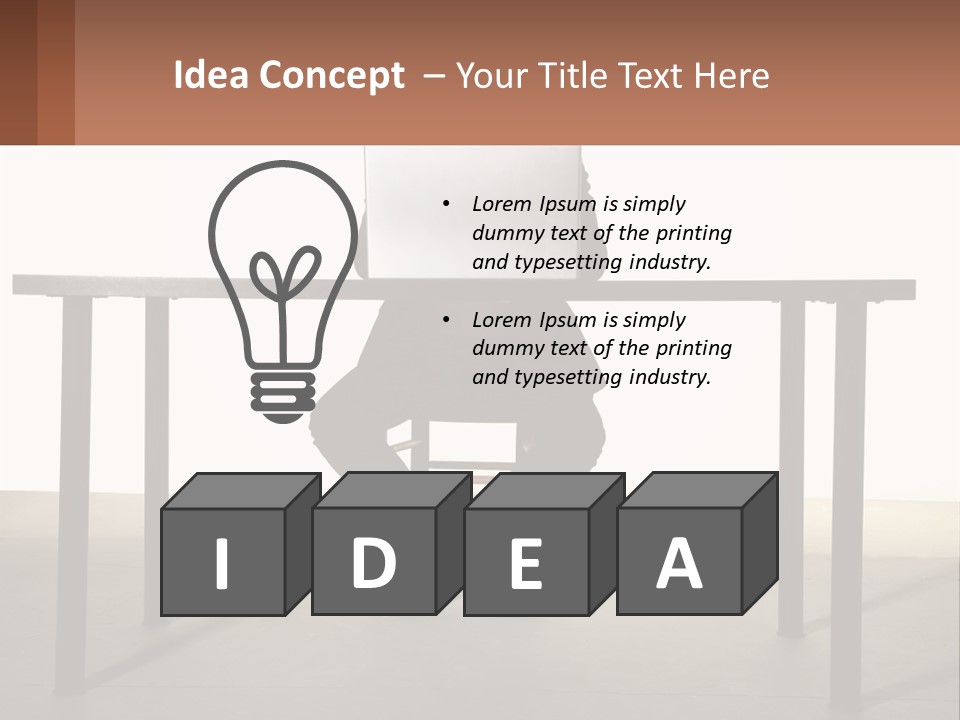 A Man Sitting At A Table Using A Laptop Computer PowerPoint Template