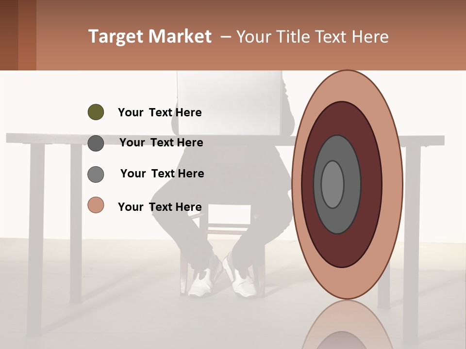 A Man Sitting At A Table Using A Laptop Computer PowerPoint Template