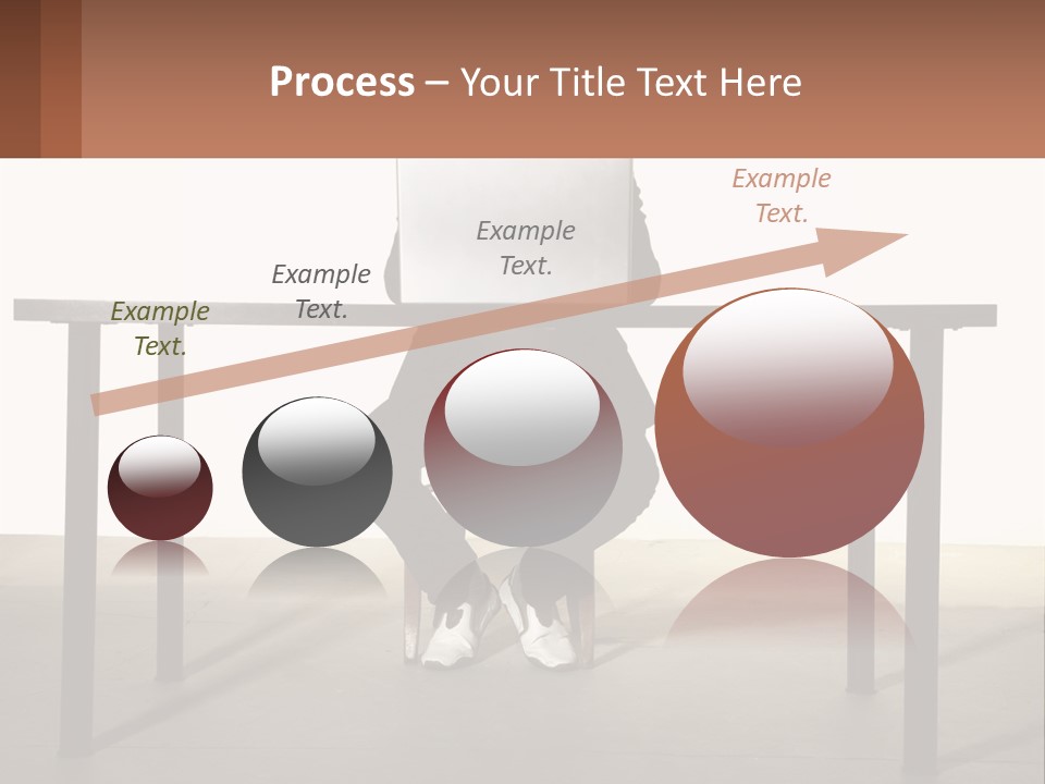A Man Sitting At A Table Using A Laptop Computer PowerPoint Template
