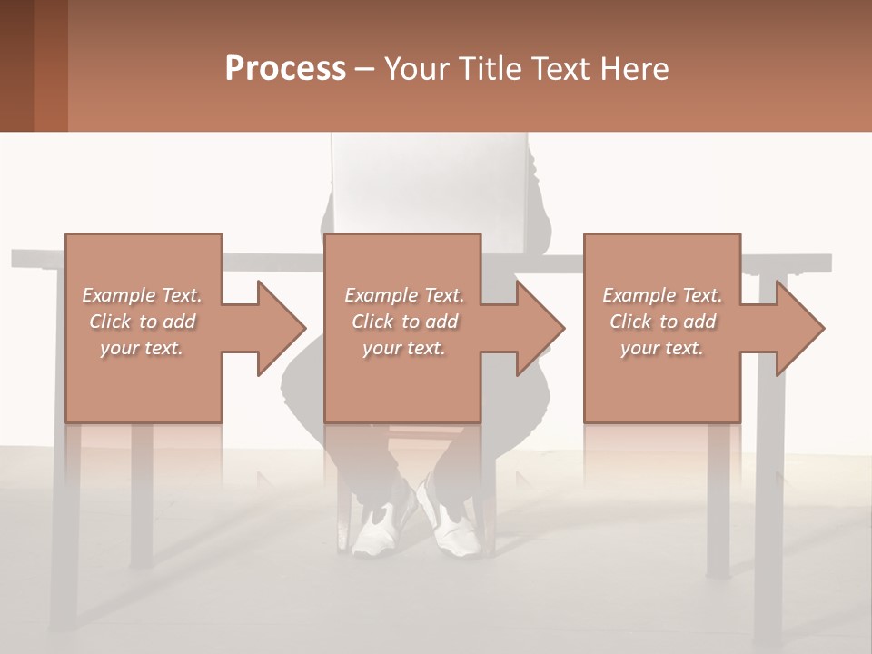 A Man Sitting At A Table Using A Laptop Computer PowerPoint Template