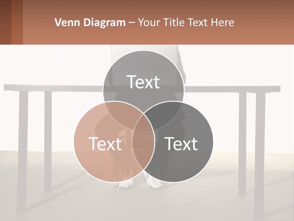 A Man Sitting At A Table Using A Laptop Computer PowerPoint Template