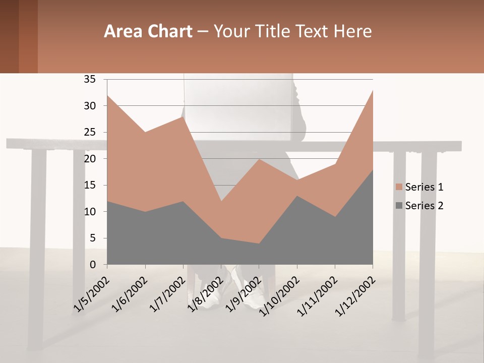 A Man Sitting At A Table Using A Laptop Computer PowerPoint Template