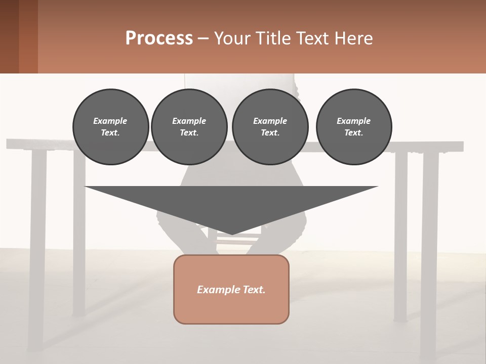 A Man Sitting At A Table Using A Laptop Computer PowerPoint Template
