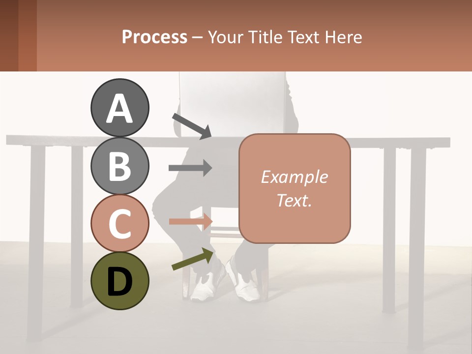 A Man Sitting At A Table Using A Laptop Computer PowerPoint Template