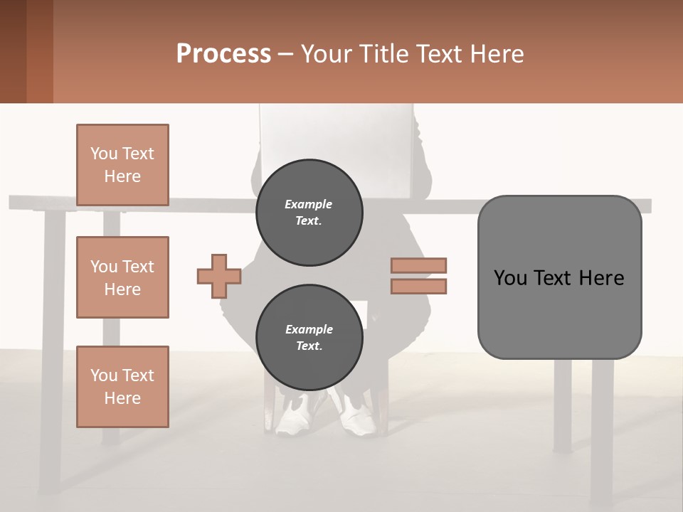 A Man Sitting At A Table Using A Laptop Computer PowerPoint Template