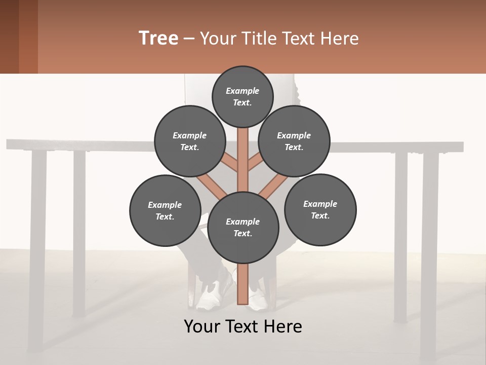 A Man Sitting At A Table Using A Laptop Computer PowerPoint Template