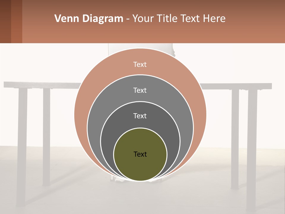 A Man Sitting At A Table Using A Laptop Computer PowerPoint Template