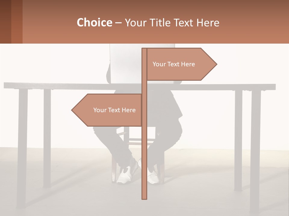 A Man Sitting At A Table Using A Laptop Computer PowerPoint Template