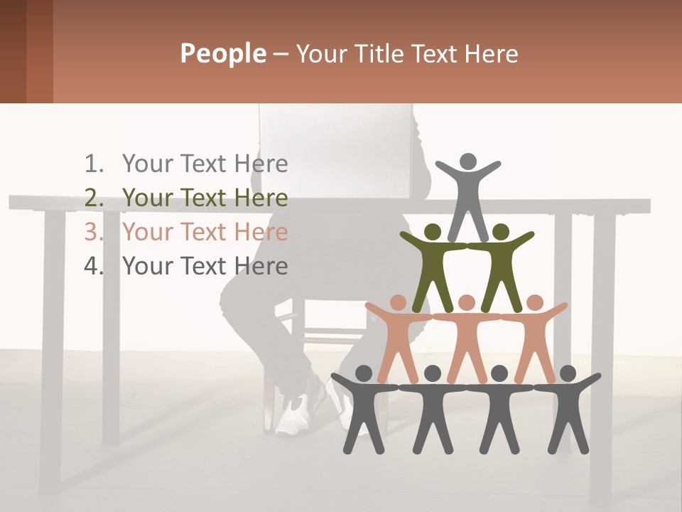 A Man Sitting At A Table Using A Laptop Computer PowerPoint Template