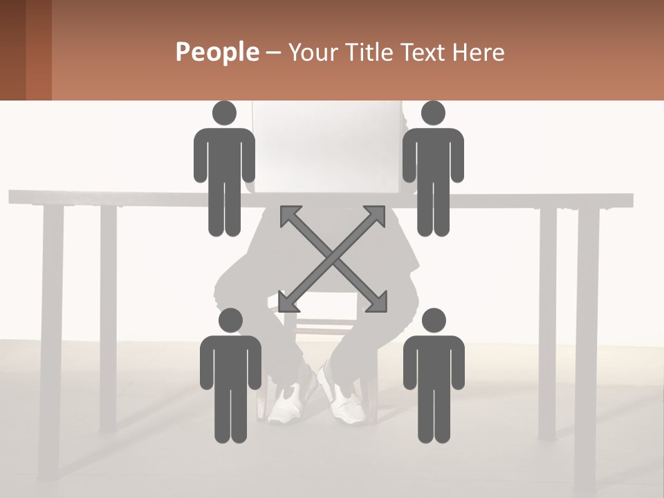 A Man Sitting At A Table Using A Laptop Computer PowerPoint Template