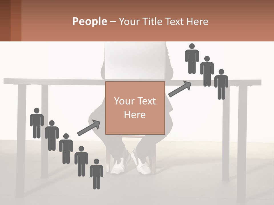 A Man Sitting At A Table Using A Laptop Computer PowerPoint Template