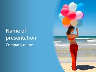 A Woman On The Beach With Balloons In Her Hand PowerPoint Template