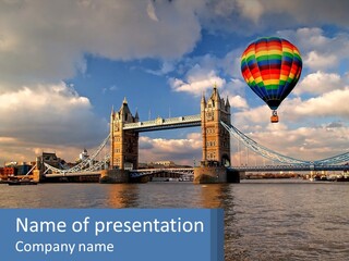 A Hot Air Balloon Flying Over A Bridge PowerPoint Template