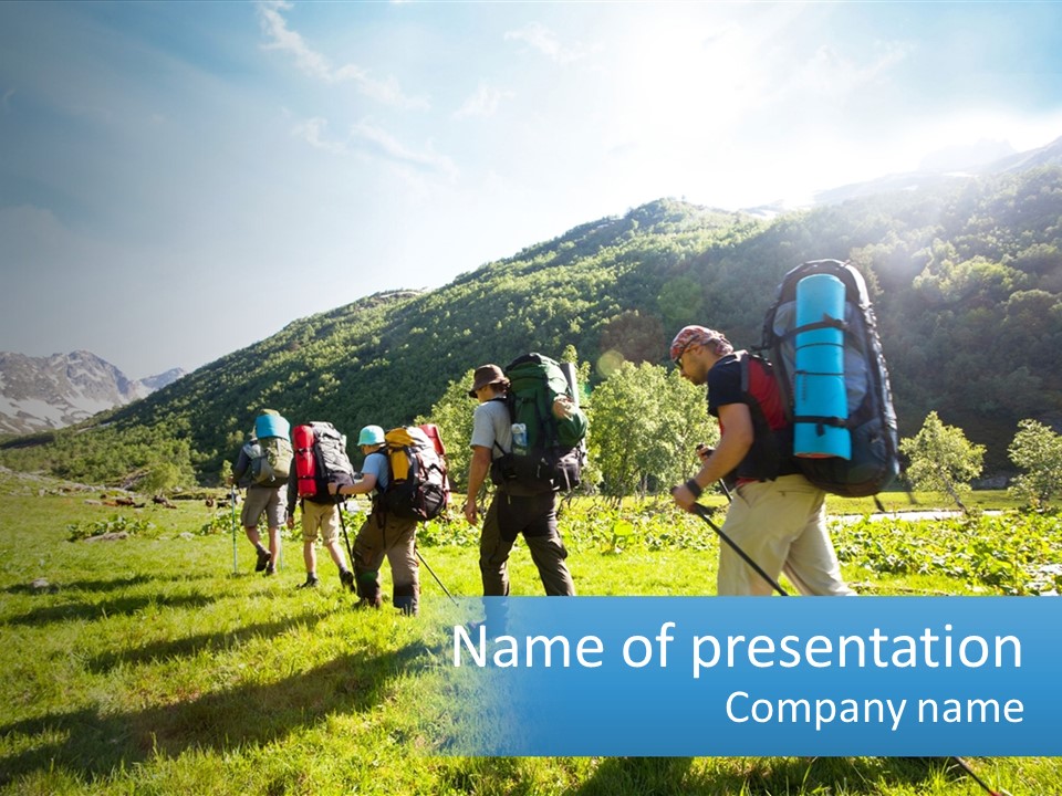 A Group Of People With Backpacks Walking Through A Field PowerPoint Template