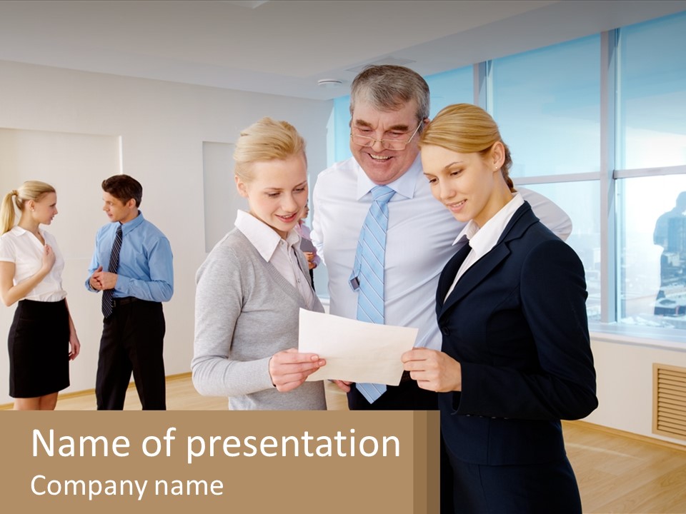 A Group Of Business People Looking At A Piece Of Paper PowerPoint Template