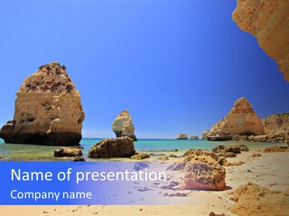 A Rocky Beach With A Rock Formation In The Background PowerPoint Template