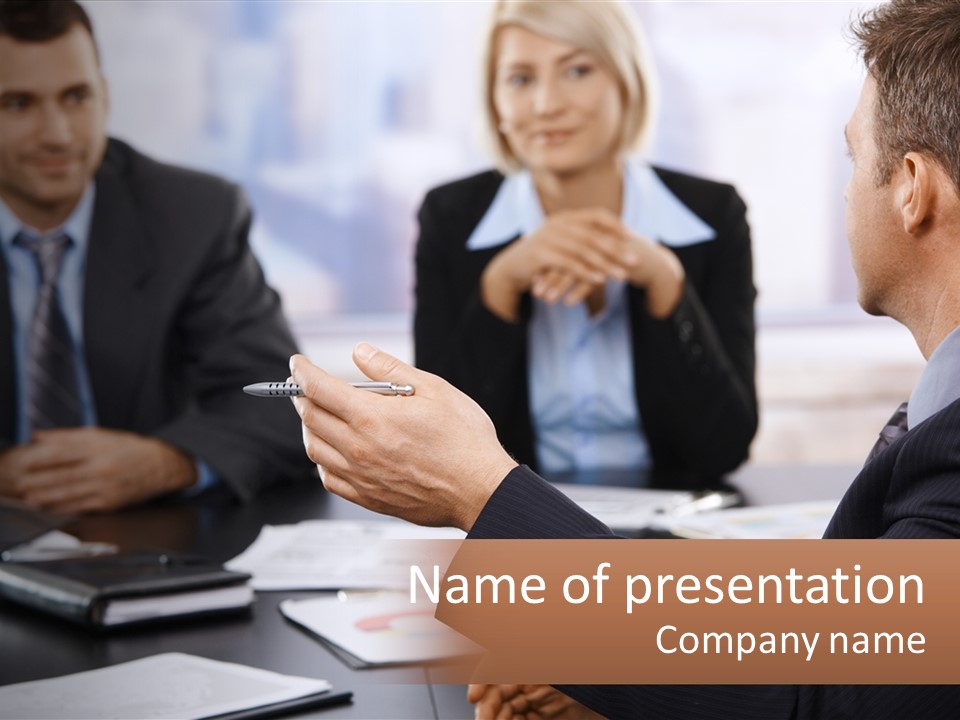 A Group Of Business People Sitting Around A Table PowerPoint Template