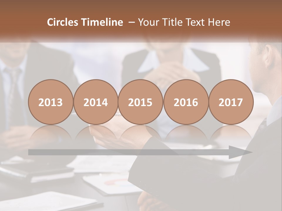 A Group Of Business People Sitting Around A Table PowerPoint Template