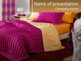 A Bedroom With A Bed Covered In A Pink And Yellow Blanket PowerPoint Template