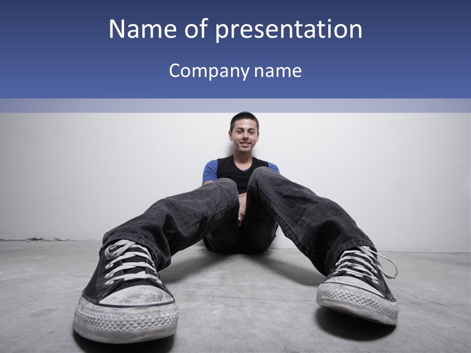 A Man Sitting On The Floor With His Feet Up PowerPoint Template