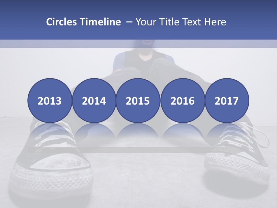 A Man Sitting On The Floor With His Feet Up PowerPoint Template