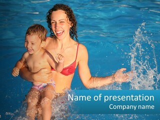 A Woman Holding A Child In A Swimming Pool PowerPoint Template