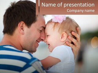 A Man Holding A Baby And Smiling At The Camera PowerPoint Template