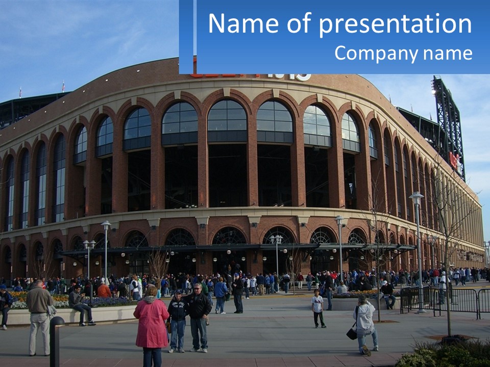 A Group Of People Standing Outside Of A Baseball Stadium PowerPoint Template