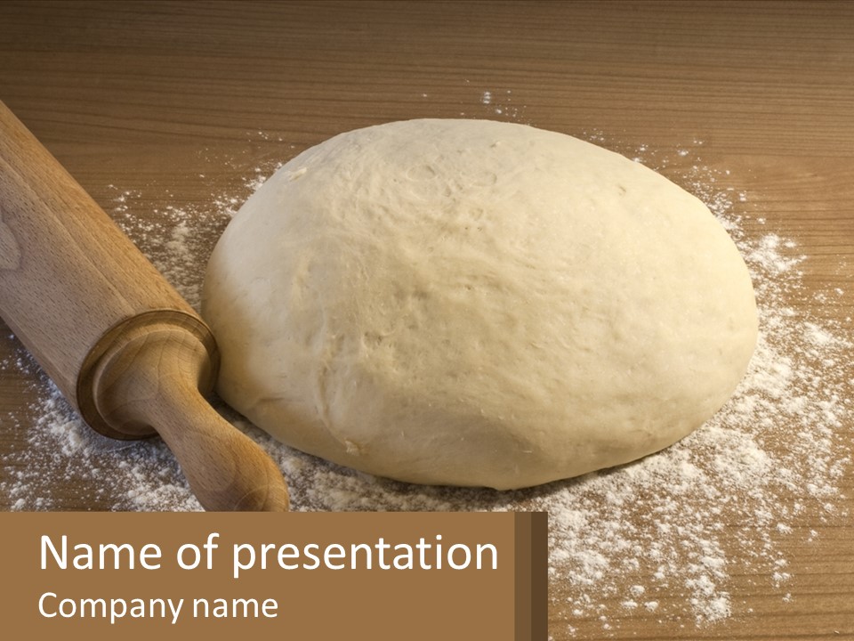 A Ball Of Dough Next To A Rolling Pin On A Table PowerPoint Template