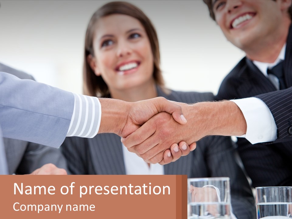 A Group Of People Shaking Hands Over A Table PowerPoint Template