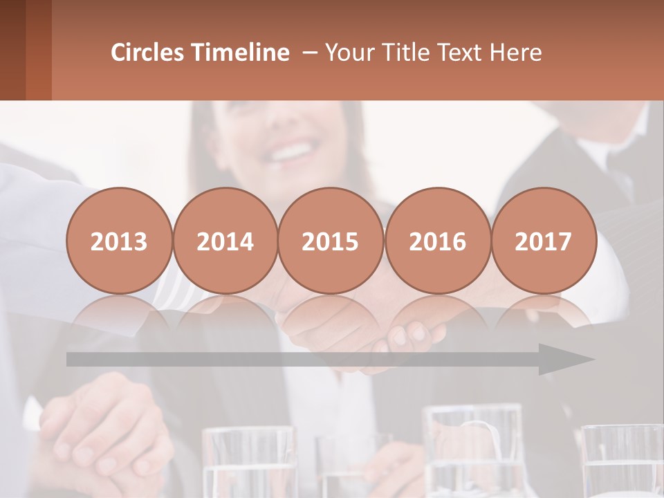 A Group Of People Shaking Hands Over A Table PowerPoint Template