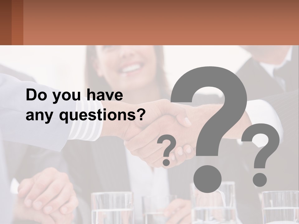 A Group Of People Shaking Hands Over A Table PowerPoint Template