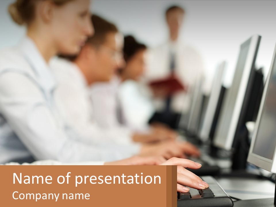 A Group Of People Working On Computers In A Row PowerPoint Template