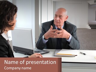 A Man And Woman Sitting At A Table With A Laptop PowerPoint Template