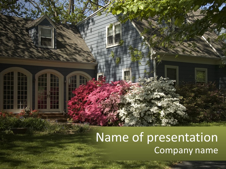 A Blue House With Pink And White Flowers In Front Of It PowerPoint Template